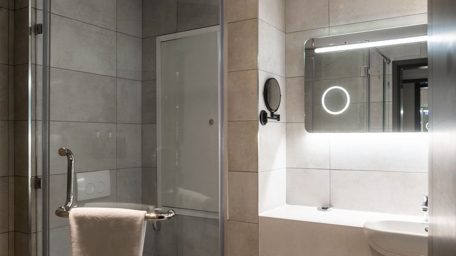 Bathroom with glass shower enclosure, toilet, and vanity at Best Western Premier Westlands.