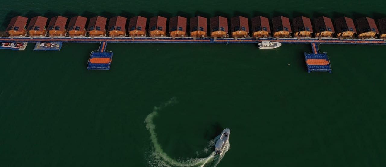 ariel and front view of the floating huts at Le ROI Floating Huts Eco Rooms captured during the day and at night13