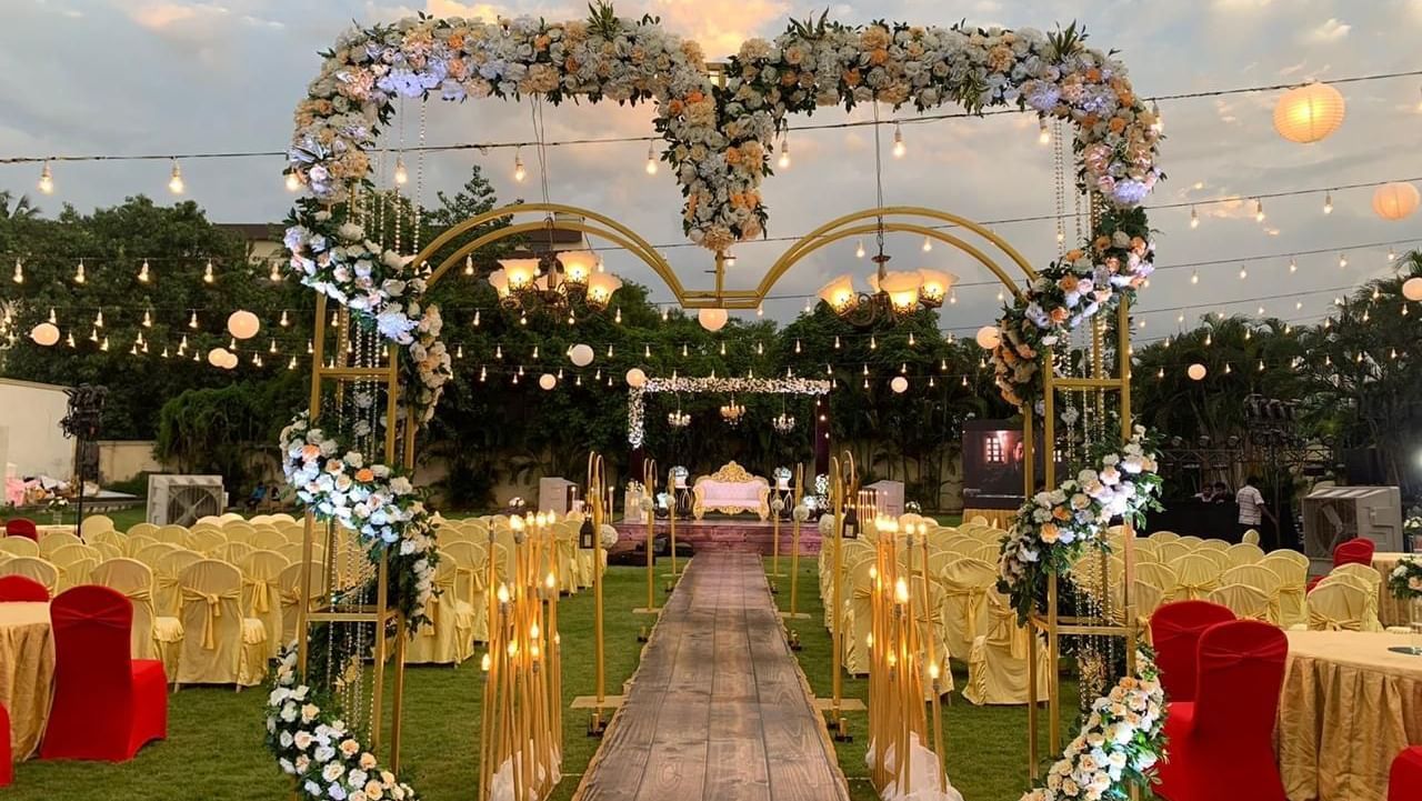 Elegant wedding entrance with heart-shaped floral arch and glowing lights at Ilara Hotels & Spa, OMR, Chennai
