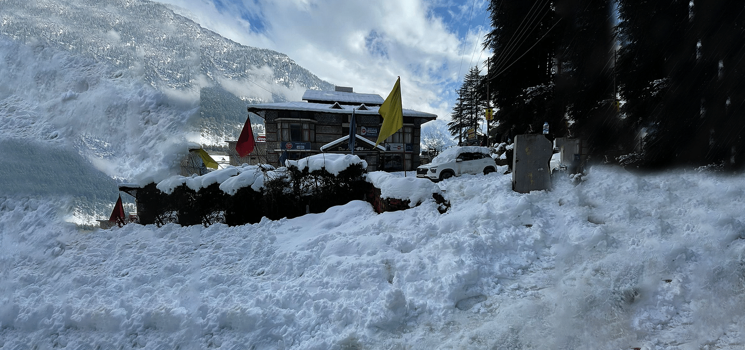 A wide view of the exterior of DLS Hotel Devlok, Manali during winters, covered in snow