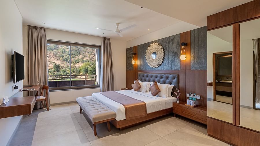 view of a king size bed and TV of Suite at Stone Wood Hotel, Kumbhalgarh
