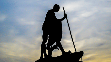 An overview of Mahatma Gandhi's statue in Marina Beach with different hues in the sky in the background.