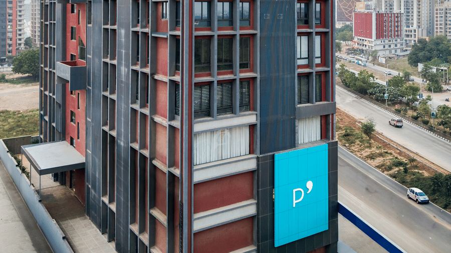 Exterior view of the multi-storey hotel building along the city road - Pride Elite Gandhinagar