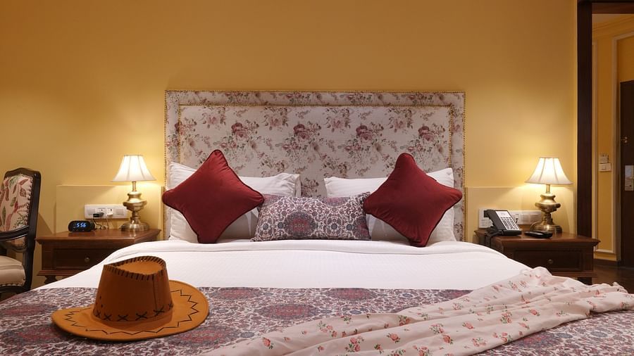 Front view of the double bed with a hat at the Suite Cottage Room at The Garden Ananta Elite Rajkot 6