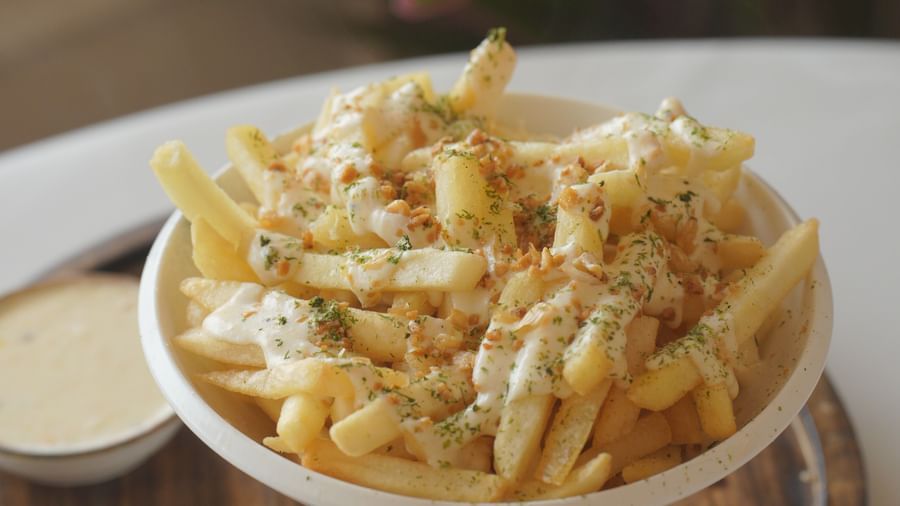Crispy French fries served in a silver bowl with dipping sauces - Mayfair Cafe & Suites, Dalhousie