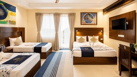 Family Room with Balcony featuring a double bed, single bed and natural daylight at Eastlynn Resort, Rishikesh.
