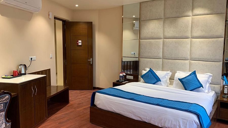 Side angle view of the room with plush bed with bedside tables - Mastiff Hotel, Dalhousie