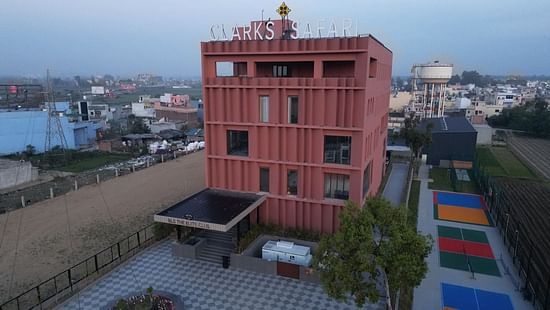 Clarks Safari Haridwar viewed from an elevated angle, showcasing a courtyard area with colourful ground markings and the surrounding urban landscape.