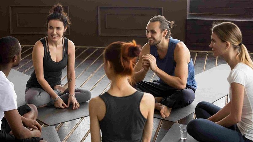 A group of people sitting and discussing animatedly