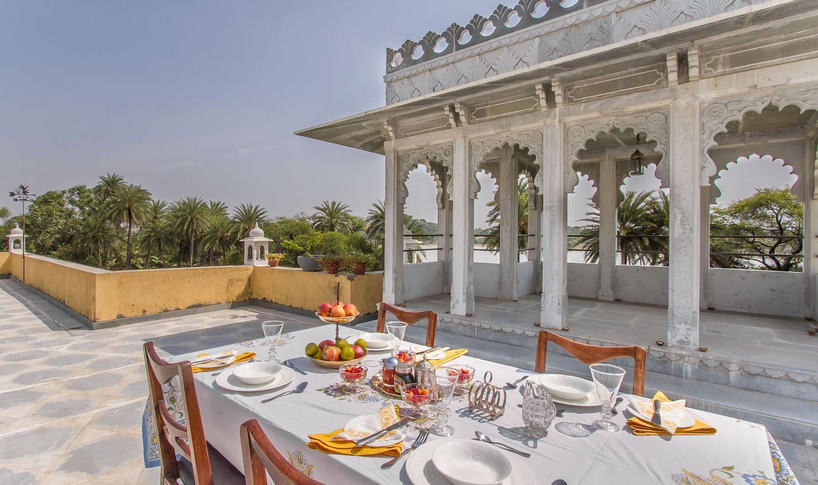 image of the Outdoor dining arrangement at Dev Shree, Deogarh overlooking beautiful views from the terrace