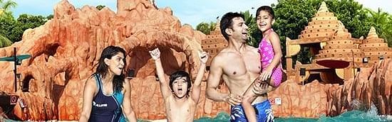 Water Kingdom -  a family of 4 standing in a pool at THE LAGOON