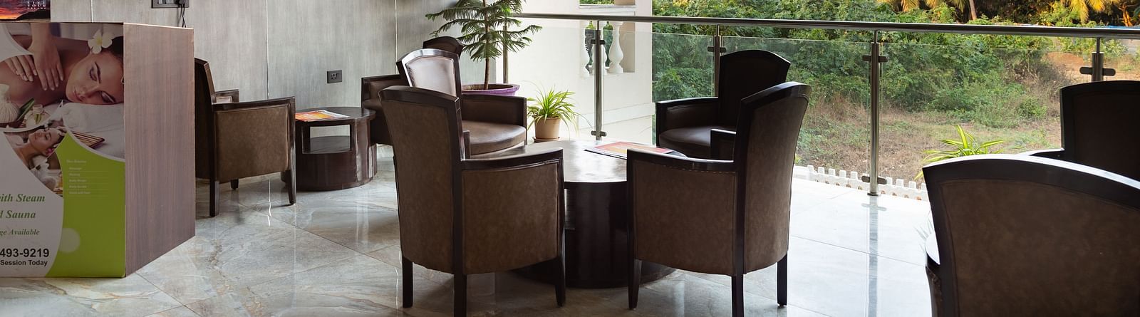 Image of a seating area with tables and chairs and a television mounted on the wall at Calux Grand Baga.