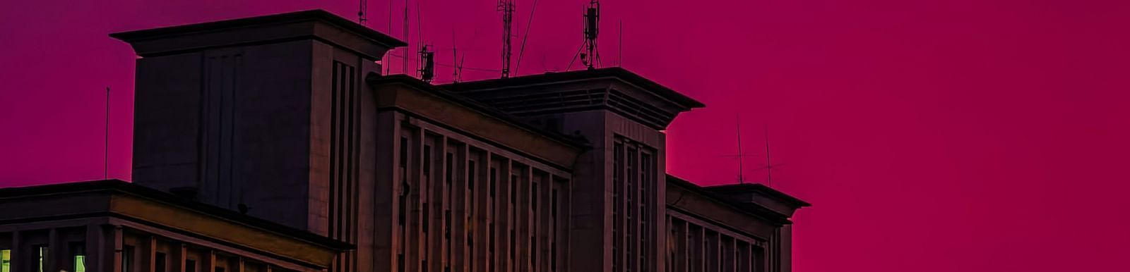 An overview Gare Centrale in Kinshasa during twilight hour with trees in view.
