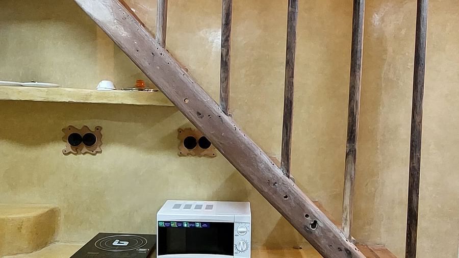 Side stairs side view with a microwave and an induction kept below the stairs.