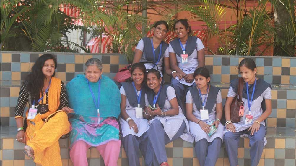 a group of school children in uniform with their teachers