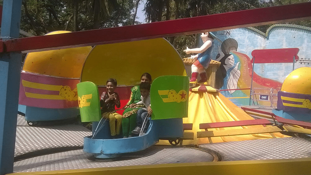 a group of people on a ride at an amusement park during daytime