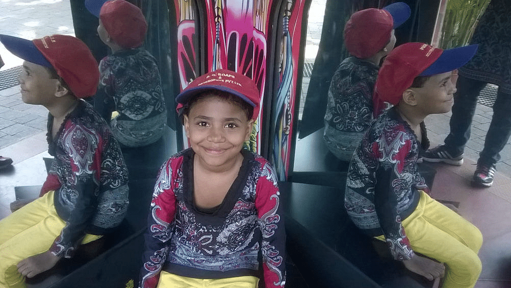 a child posing by 2 mirrors