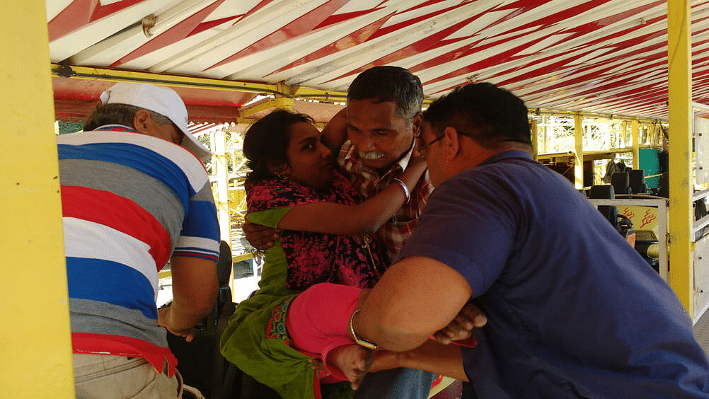 people helping another person onto a ride