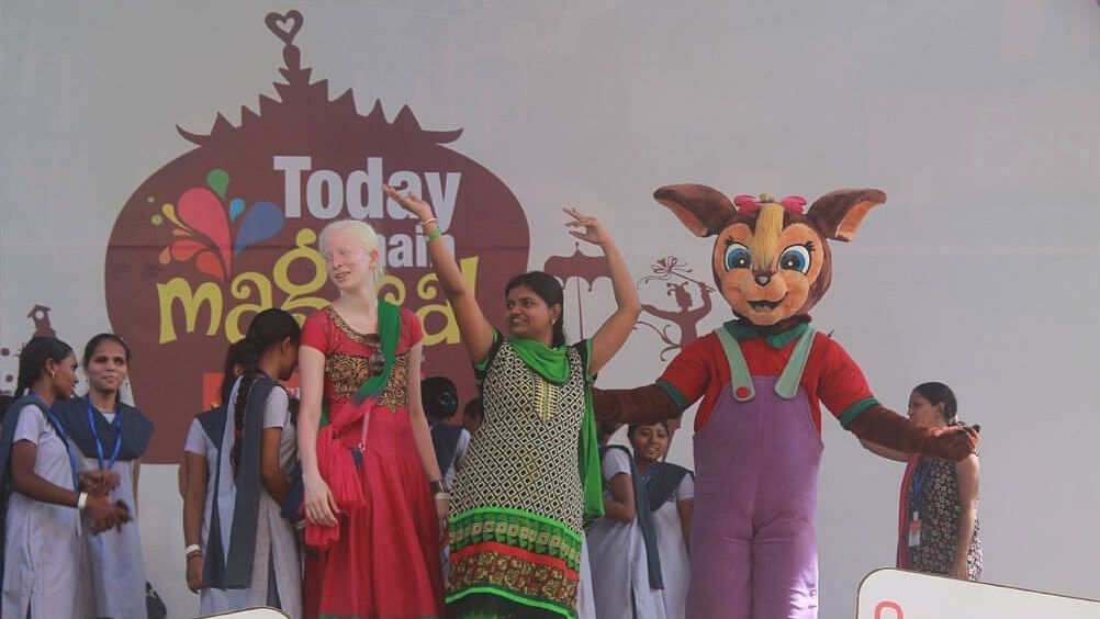 Water Kingdom - a group of people and a mascot on a stage