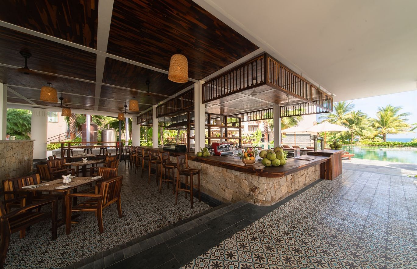 An image of a restraunt that has different kinds of fruits and chairs are placed on the other side - Alibu Resort Nha Thrang
