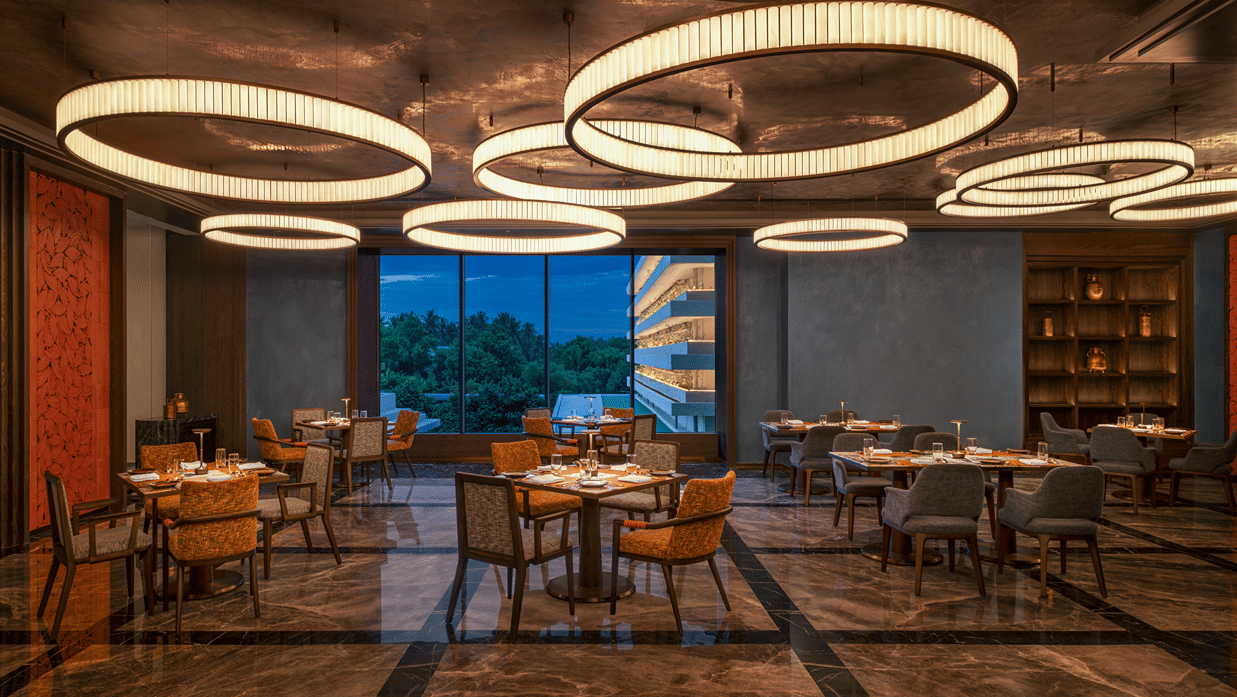 Grand Trunk restaurant seating area with circular pendant lighting at The Residency Signature Madurai.