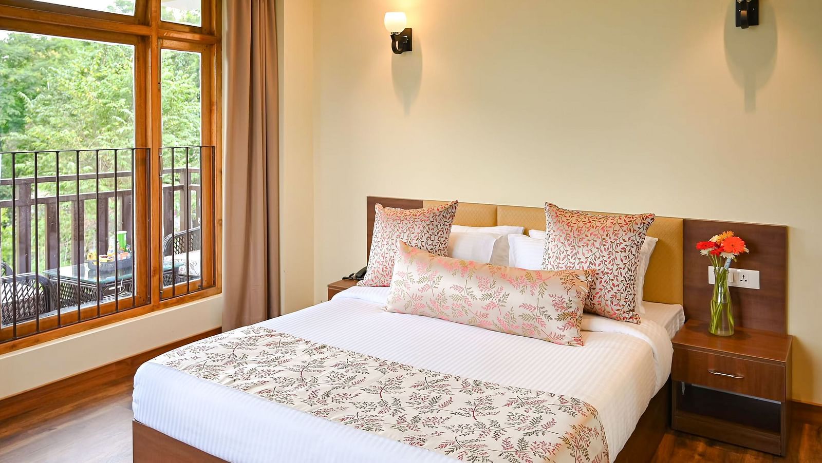 the premier room with balcony at Yashshree Karbari Resort & Spa, Yangang featuring a queen size bed besides a huge window