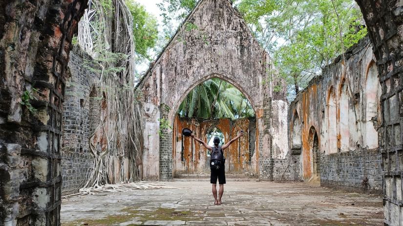 A person posing while inside an ancient church on Ross Island