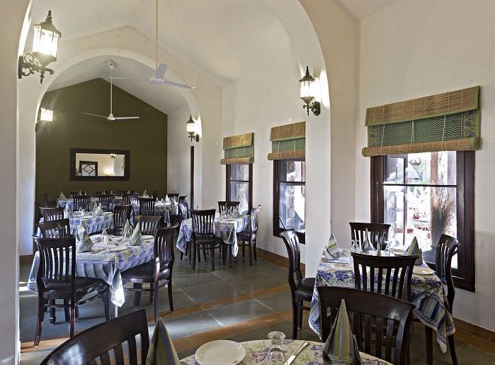 An image of the seating arrangement at with minimal decoration Taasli Restaurant of Manvar Shergarh - Manvar Resort & Desert Camp