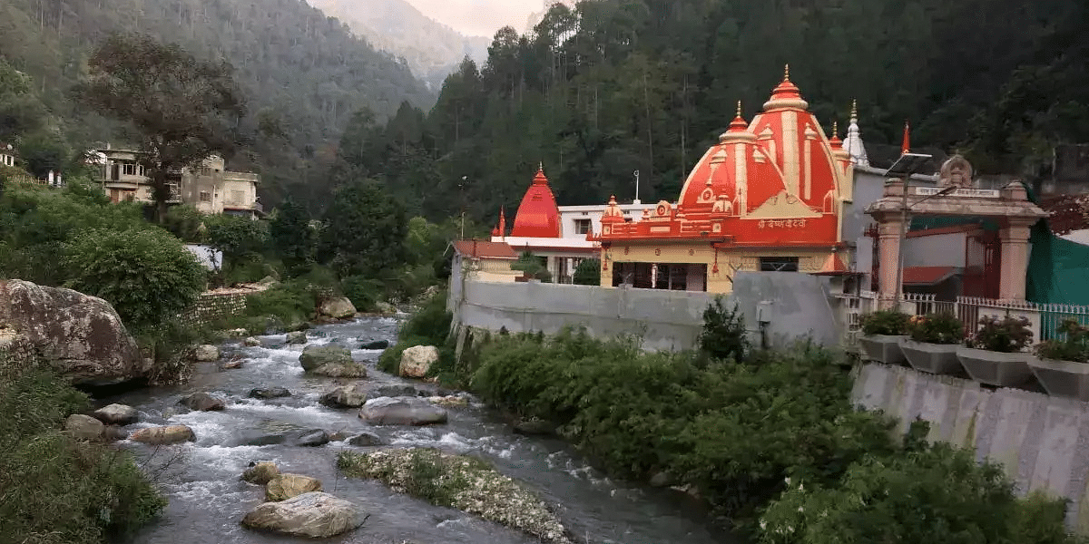 An image of a temple near a stream