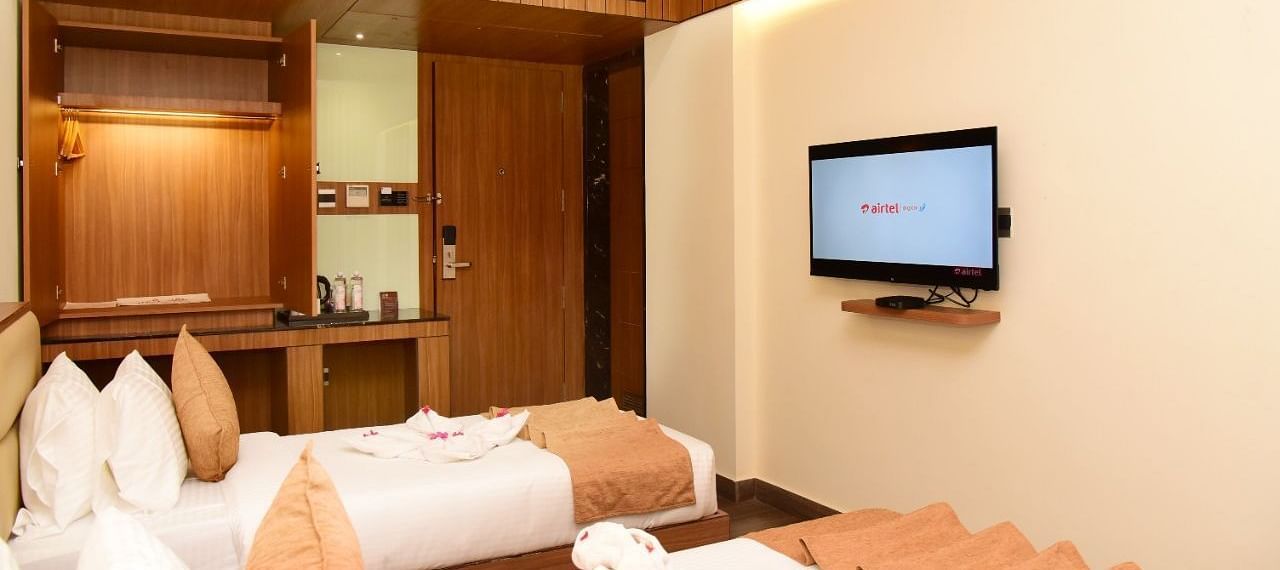 Twin beds with an LCD Television at TGI Felicity, Bangalore
