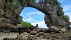 people posing in front of howrah bridge on neil island with blue sky in the background