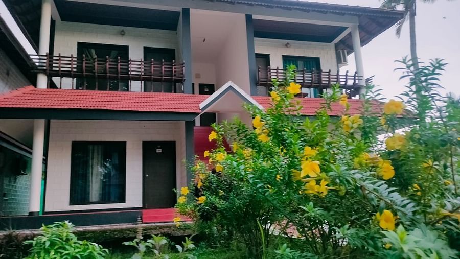 exterior of a cottage building with flowering plants and a garden outside