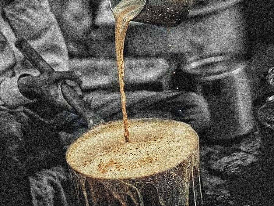 a man pouring cutting chai in a vessel