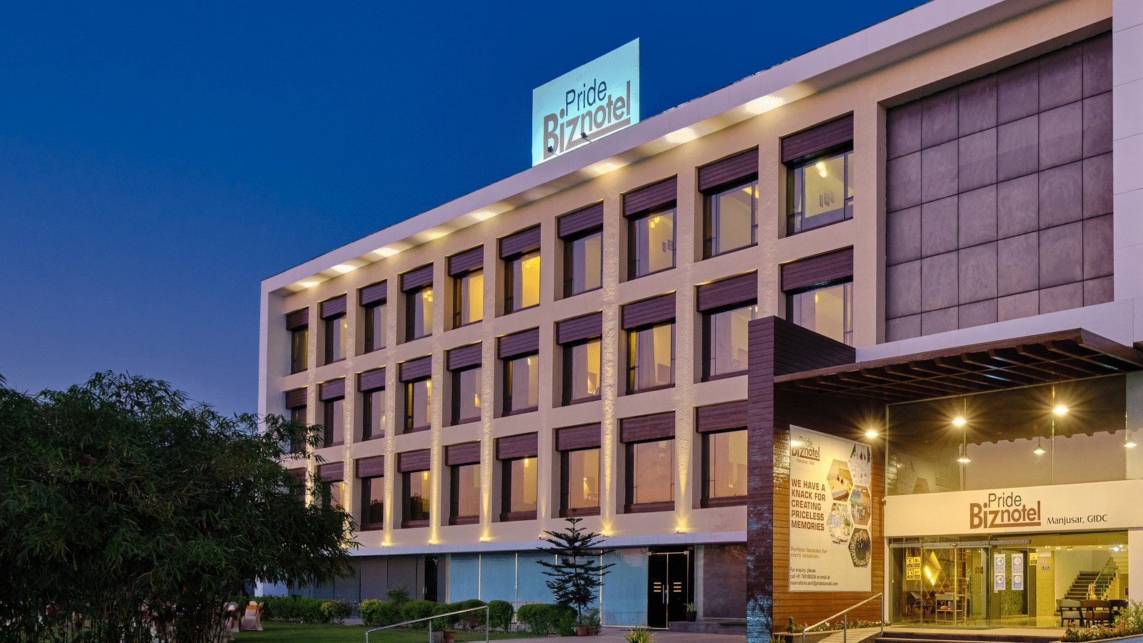 Pride Biznotel Manjusar - closer view of hotel exterior during evening
