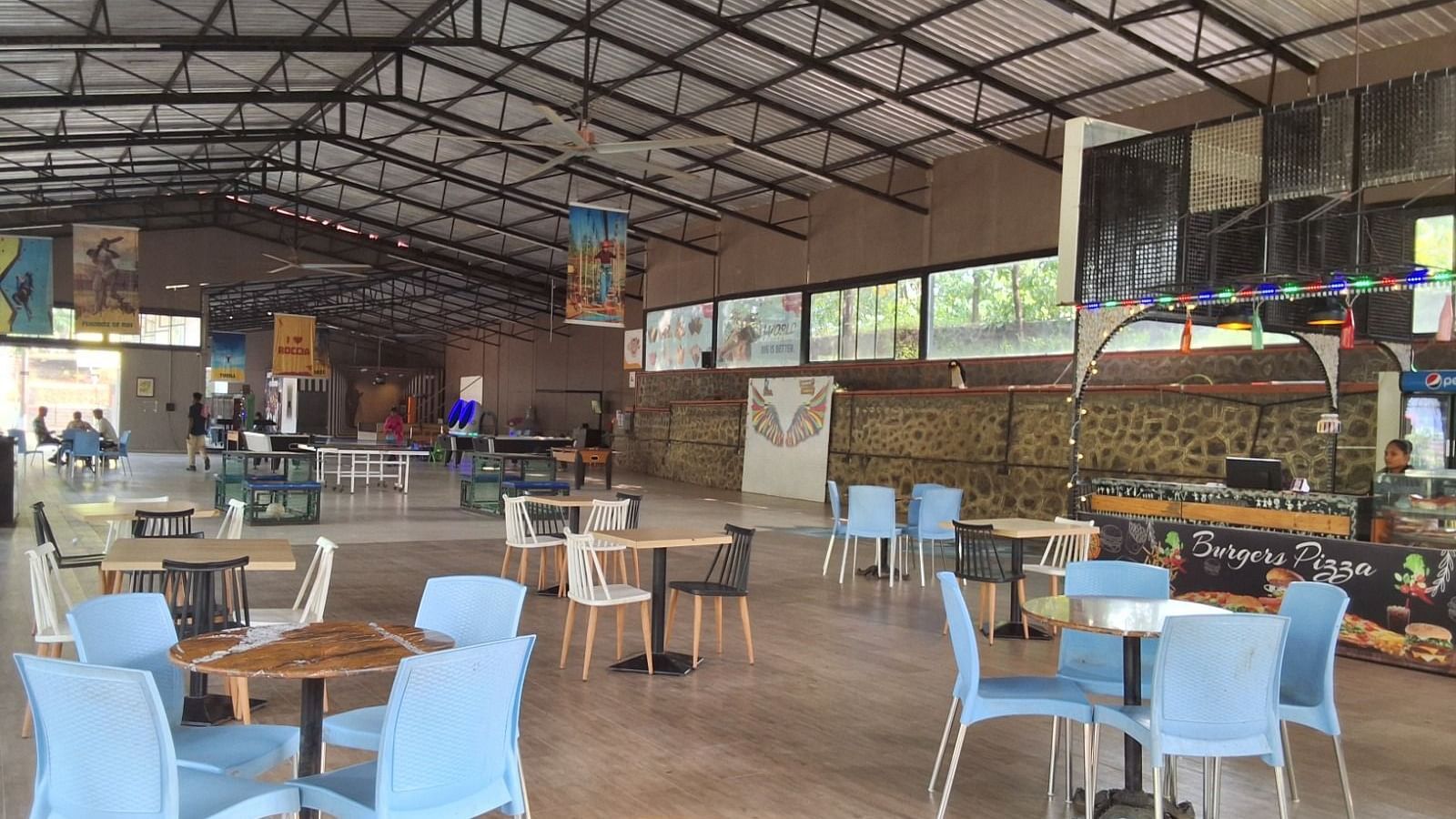 an image of tables and chairs arranged for the guests in the munching cafe at VITS Roccia Hill Resort & Adventure Park