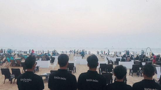 5 hotel team members standing side by side, facing behind looking at the beach | Amara Oceanfront Resort, Baga,