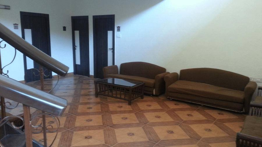 The lobby of the bungalow at the resort furnished with twin sofas and a centre table.