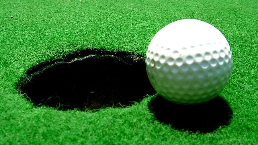 a golf ball lying on a green field