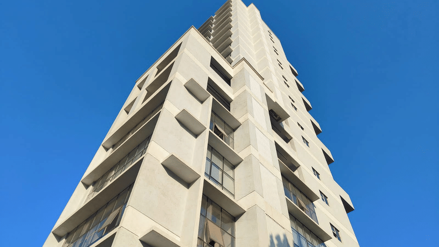 facade images of Maxxvalue Hotel, Chitranjan Tower, Powai, showcasing the concrete building from a lower angle1