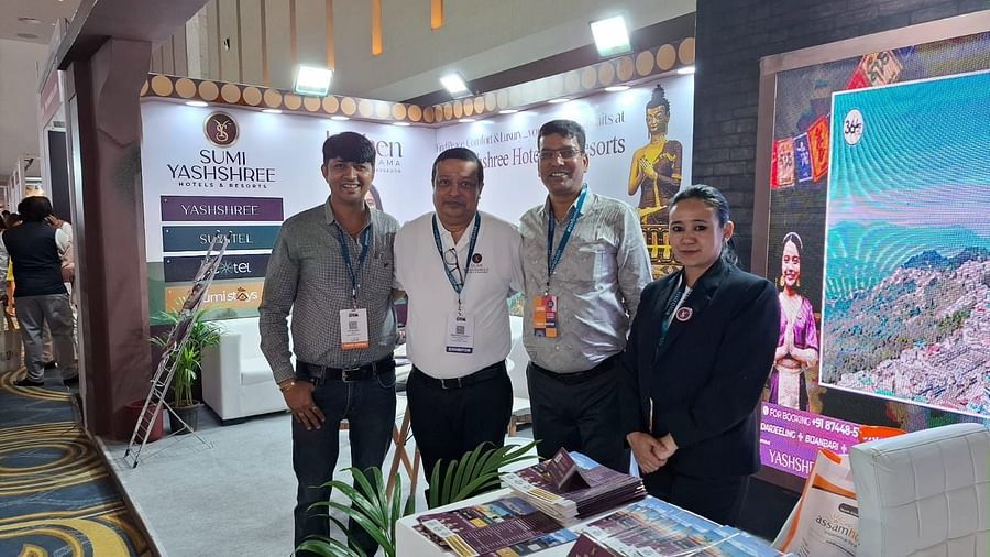 Team members at the Sumi Yashshree Hotels & Resorts booth, showcasing their hospitality services and engaging with visitors to promote luxury getaways.