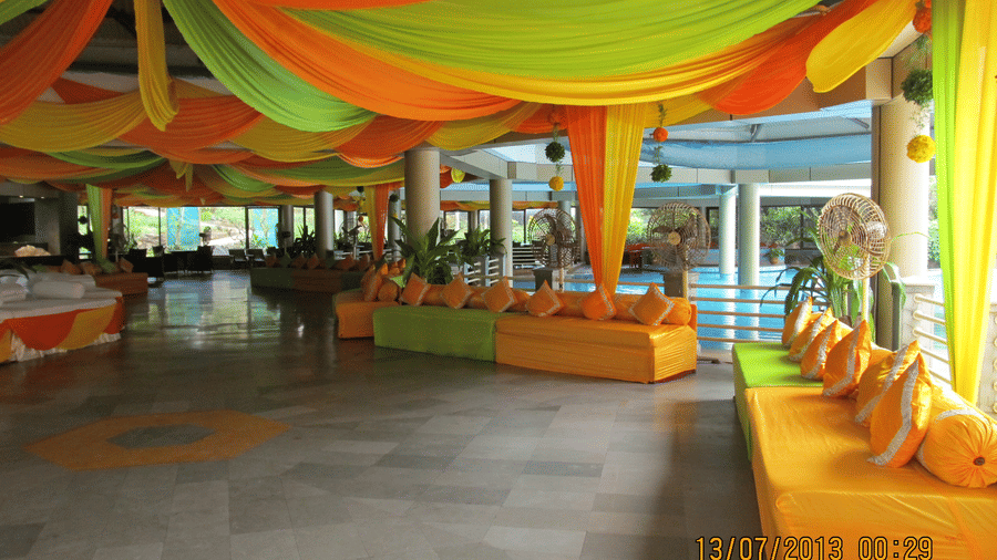 A seating area for an event at The Retreat Hotel and Convention Centre, with colourful cloths tied all around.