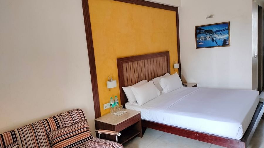 An image of bedroom with a bedside table, and a sofa next to it - VITS Lonvala