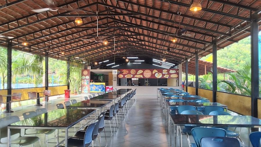 An image of restaurant with open sides, featuring tables and chairs for a lively dining experience at VITS Roccia Hill Resort & Adventure Park.