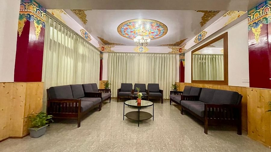 Sofas arranged around a teapoy in the lobby area that has vibrant wall decor | Voyage The Royal Retreat, Gangtok