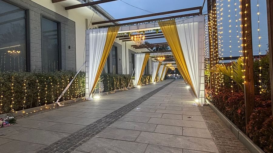 Wedding entrance with a canopy, pathway, and floral decor.