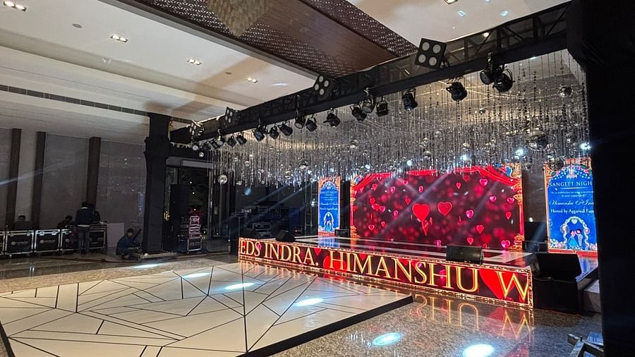 Spacious indoor hall with a large stage setup featuring vibrant lighting and a modern design.