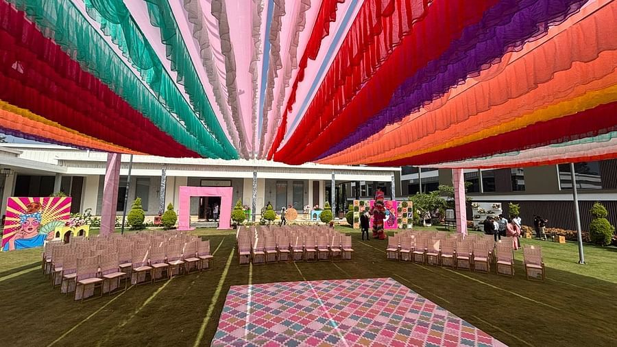 An image of a lawn decorated with  colourful fabrics, flowers, designed carpets, chairs,and other decorative items to organise an event - VRR Astoria Hotel and Convention Centre
