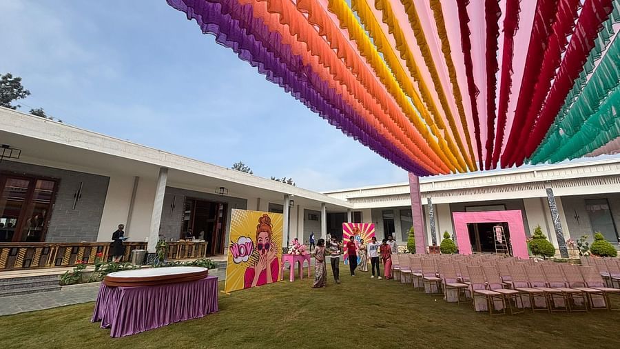 An image of a lawn decorated with  colourful fabrics, flowers, designed carpets, chairs,and other decorative items to organise an event - VRR Astoria Hotel and Convention Centre