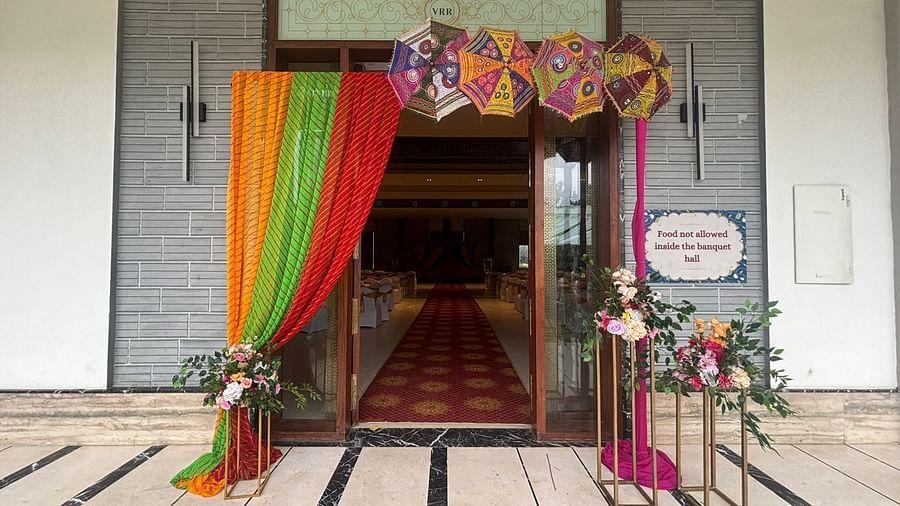 A picture featuring the entrance, with intricate floral designs and green plants as part of the decoration.