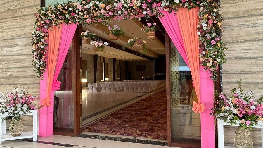 Lavishly decorated entrance with vibrant pink drapes and floral accents at VRR Astoria.